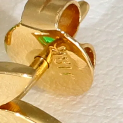 Originelles Set bestehend aus Ohrsteckern und Anhänger aus 750 / 18K Gold mit eingefassten Smaragden in exotischem Blatt - Design