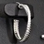 Glänzende Creolen / Ohrringe aus 925 Silber, rhodiniert und poliert, besetzt mit vielen, kleinen funkelnden Zirkonia-Steinen im Brillantschliff