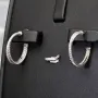 Glänzende Creolen / Ohrringe aus 925 Silber, rhodiniert und poliert, besetzt mit vielen, kleinen funkelnden Zirkonia-Steinen im Brillantschliff