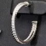 Glänzende Creolen / Ohrringe aus 925 Silber, rhodiniert und poliert, besetzt mit vielen, kleinen funkelnden Zirkonia-Steinen im Brillantschliff