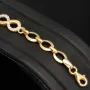 Glänzendes Goldarmband mit Infinity-Elementen mit weißen Zirkoniasteinen in 585 14K Gold in (ca. 18,5 cm Länge, ca. 6 mm Breite)