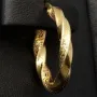 Glänzende Greco-Creolen in zeitlosem Twist-Design aus funkelndem 585er / 14K Gold