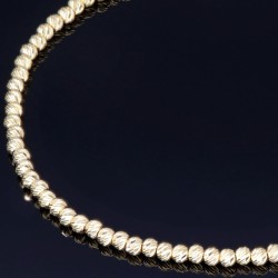 Längenverstellbares Infinity-Armband bestehend aus vielen kleinen Goldkügelchen aus 585 14K Gelbgold in ca. 18,5 - 20 cm Länge mit Zirkoniastein