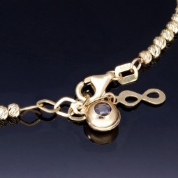 Längenverstellbares Infinity-Armband bestehend aus vielen kleinen Goldkügelchen aus 585 14K Gelbgold in ca. 18,5 - 20 cm Länge mit Zirkoniastein