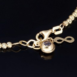 Längenverstellbares Infinity-Armband bestehend aus vielen kleinen Goldkügelchen aus 585 14K Gelbgold in ca. 18,5 - 20 cm Länge mit Zirkoniastein