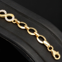 Glänzendes Goldarmband mit Infinity-Elementen mit weißen Zirkoniasteinen in 585 14K Gold in (ca. 18,5 cm Länge, ca. 6 mm Breite)