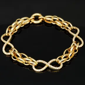 Exklusives Goldarmband mit eingearbeiteten Unendlichkeits-Elementen präzise besetzt mit weißen Zirkoniasteinen in 585 14K Gold in (ca. 20 cm Länge, ca. 9 mm Breite)
